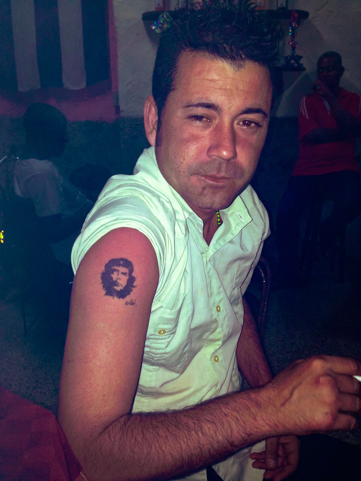 A local man poses with his Che Guevara tattoo on his arm in a bar in Havana, Cuba.