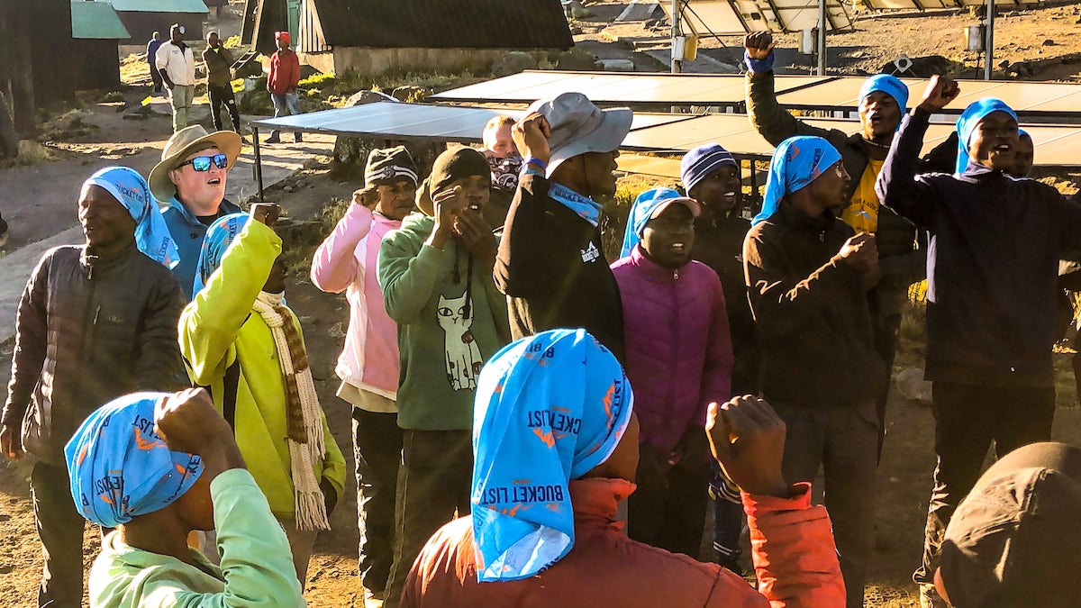 A group of Africans sing and dance on Mount Kilimanjaro. 