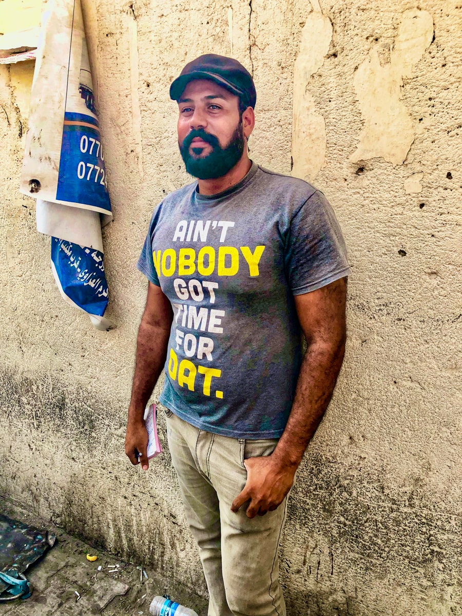 Local man in Baghdad with a funny t-shirt on smiles
