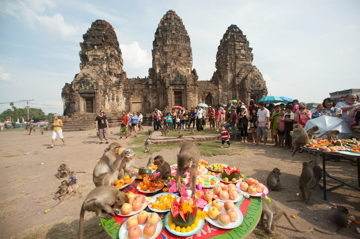 Monkeys feast on fruits outside Khmer ruins at a Thailand Festival outside of Bangkok.