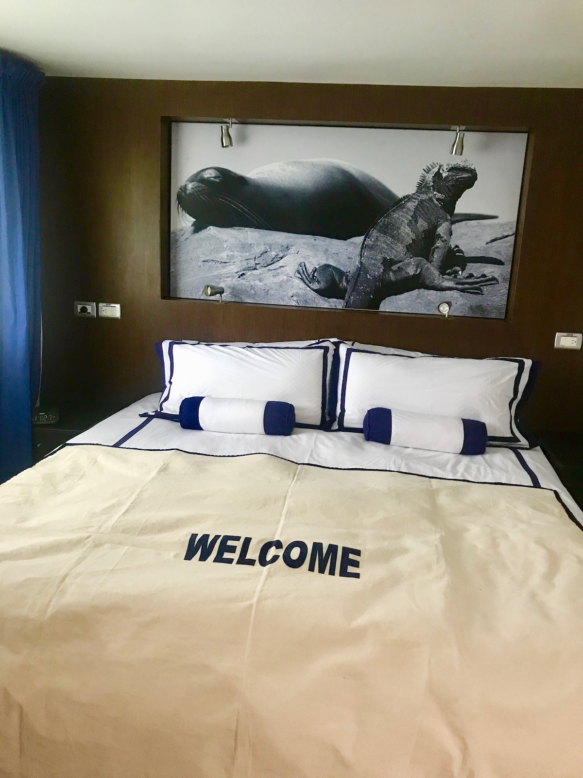 A white bed with a photo of a lizard and a sea lion in black and white 