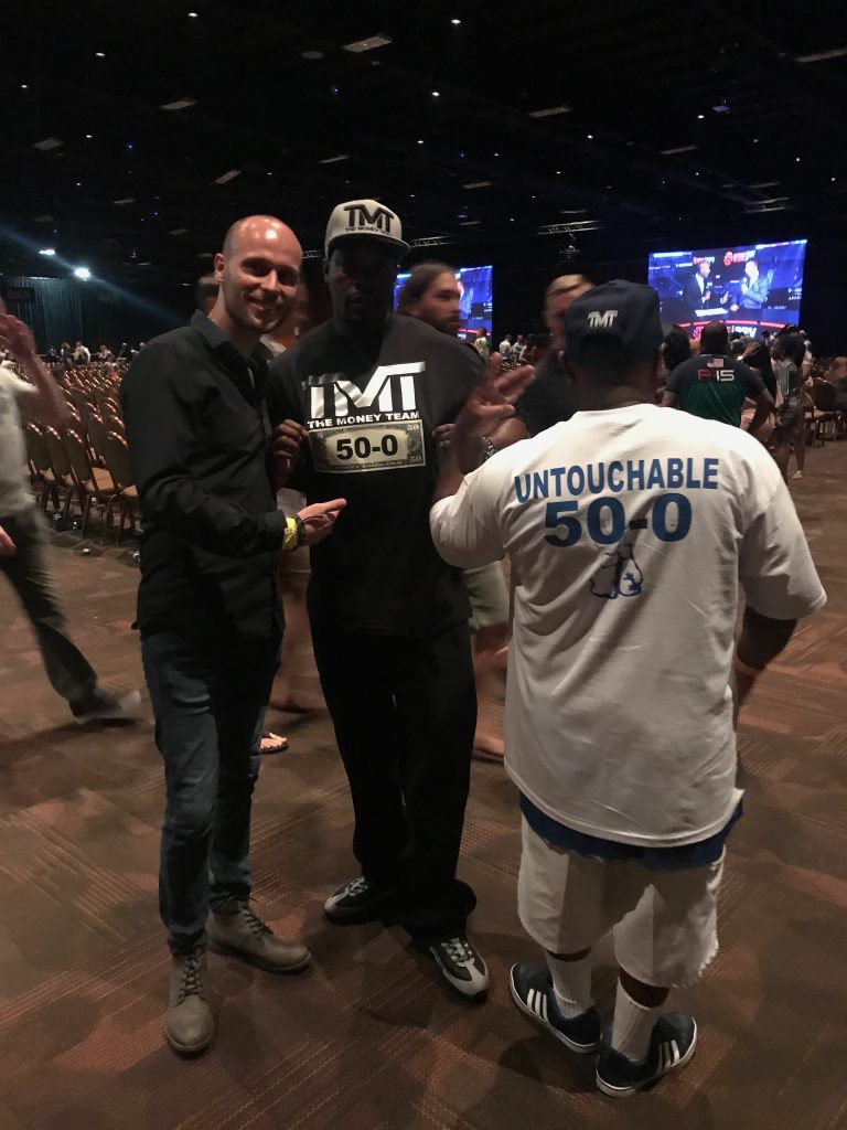 A man poses with 2 Floyd Mayweather fans at the MGM Arena in Las Vegas
