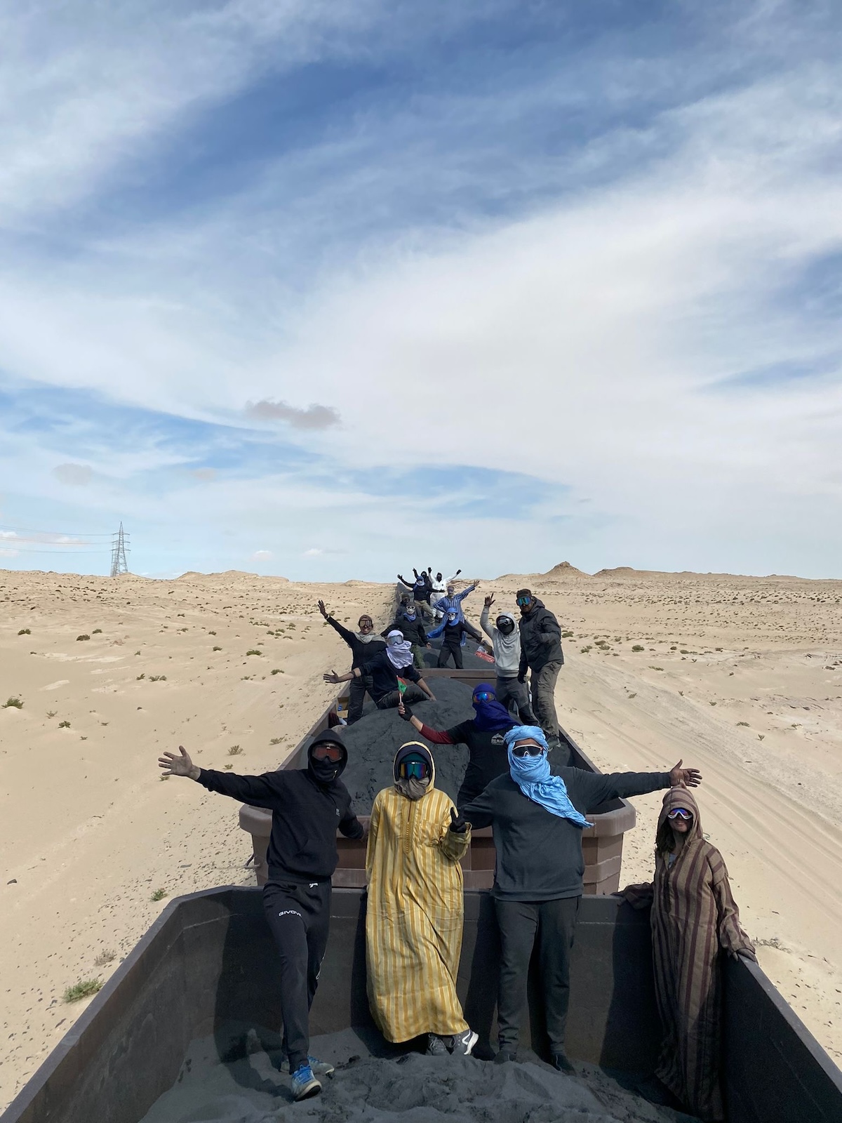 Tourists pose on top of the iron ore train of Mauritania 