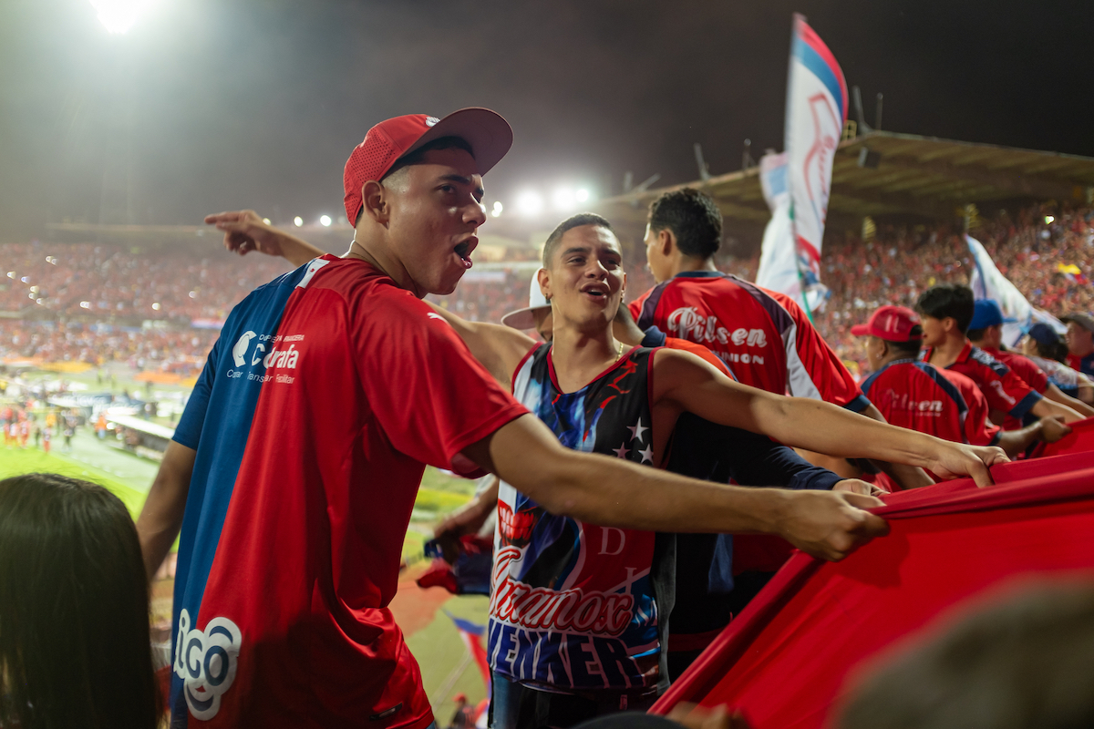 People Cheering at Football Cup Final Game at Night in Medellin 