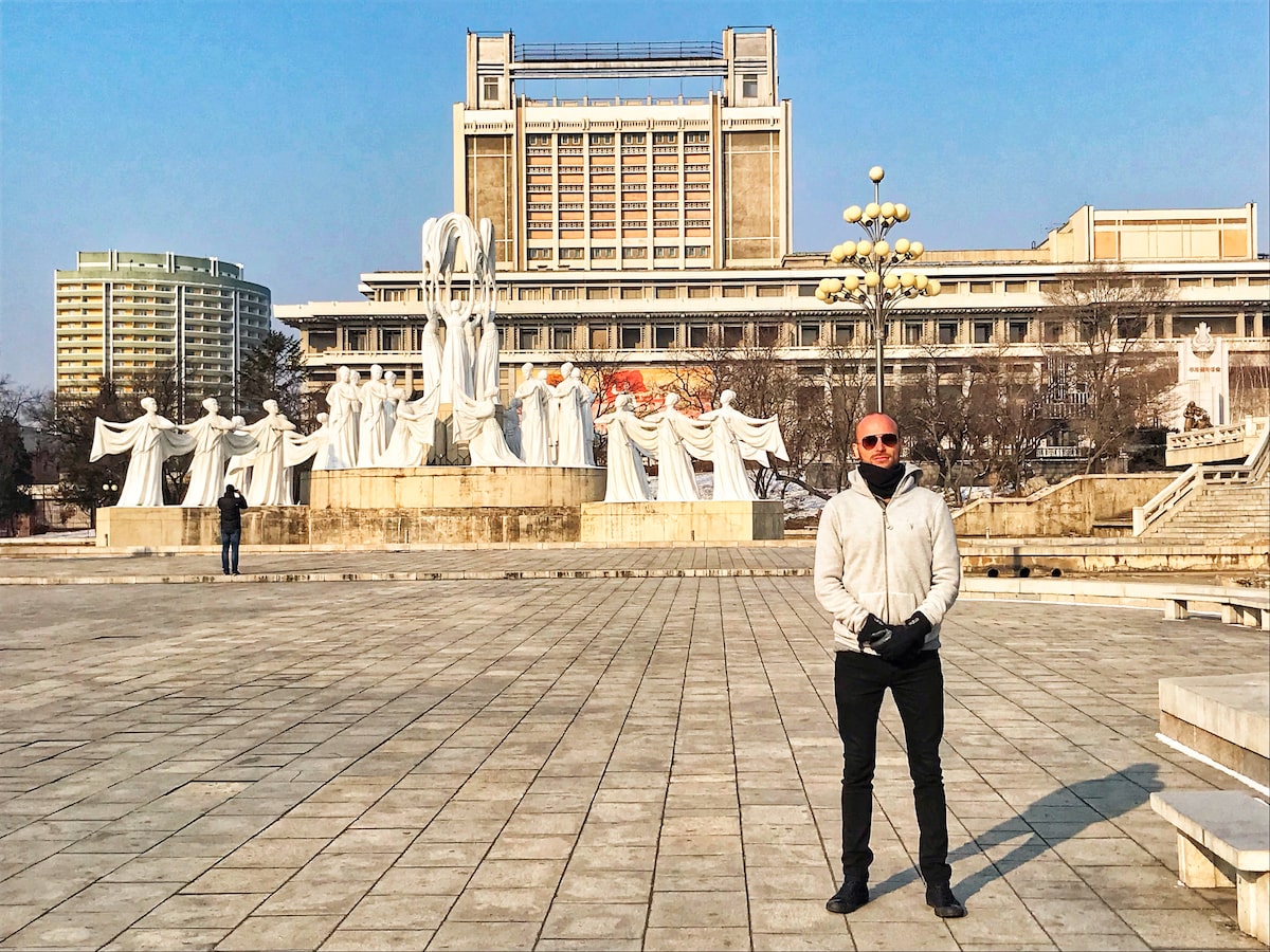A male tourist poses without smiling in a photo taken in Pyongyang, as some North Korea rules for tourists are to not smile in front of certain moments in the country.
