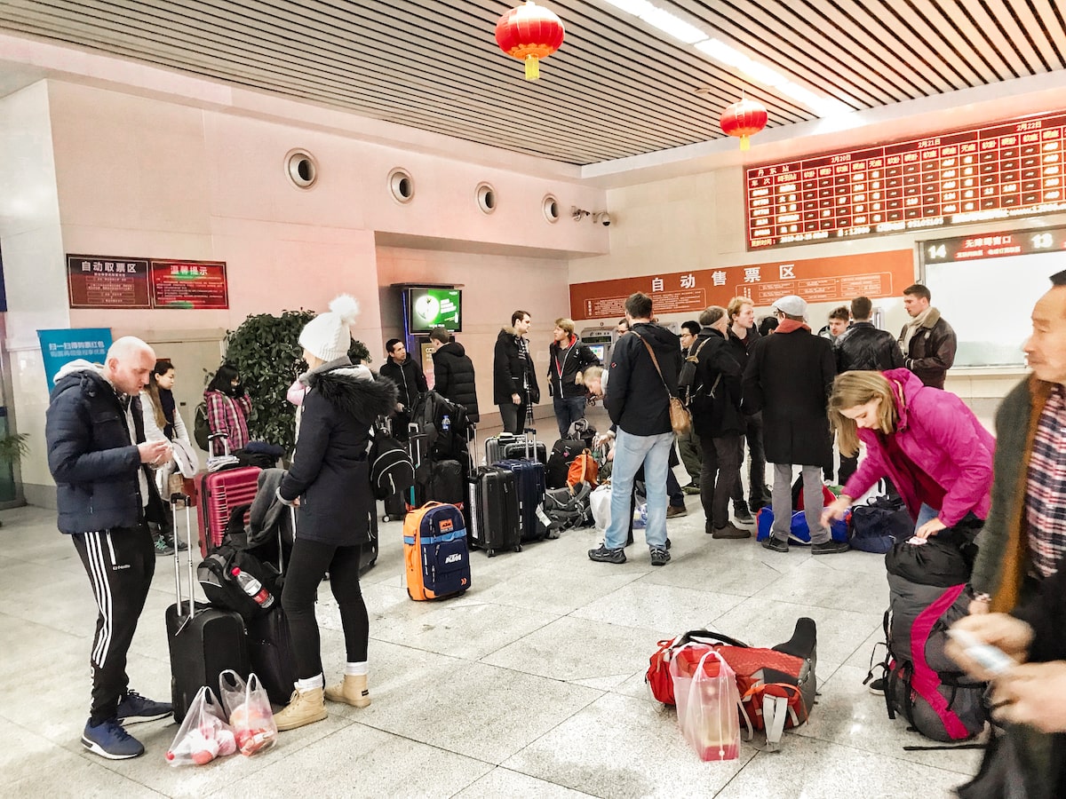 Tourists congregate in a train station