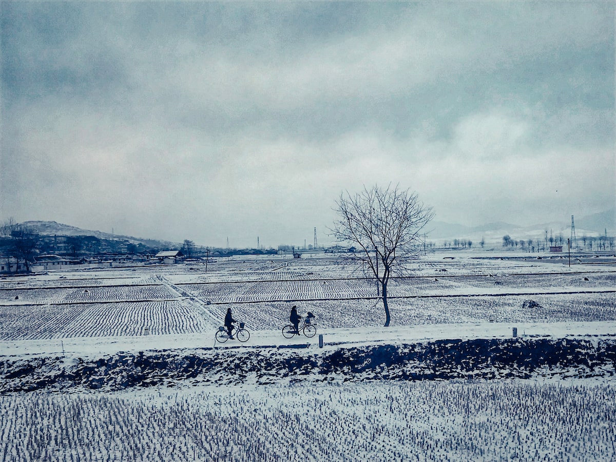 North Koreans experience cycling in the snow during winter