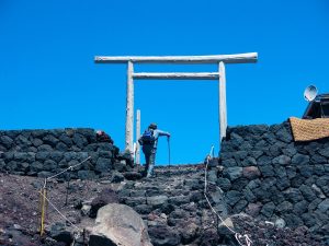 Elderly man climbing to the top of a mount on Mount Fuji, Japan