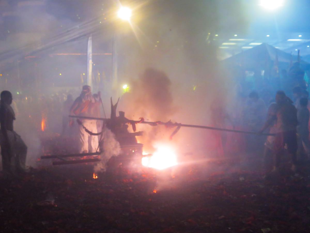 Fireworks and smoke in a street procession in Phuket, Thailand. 