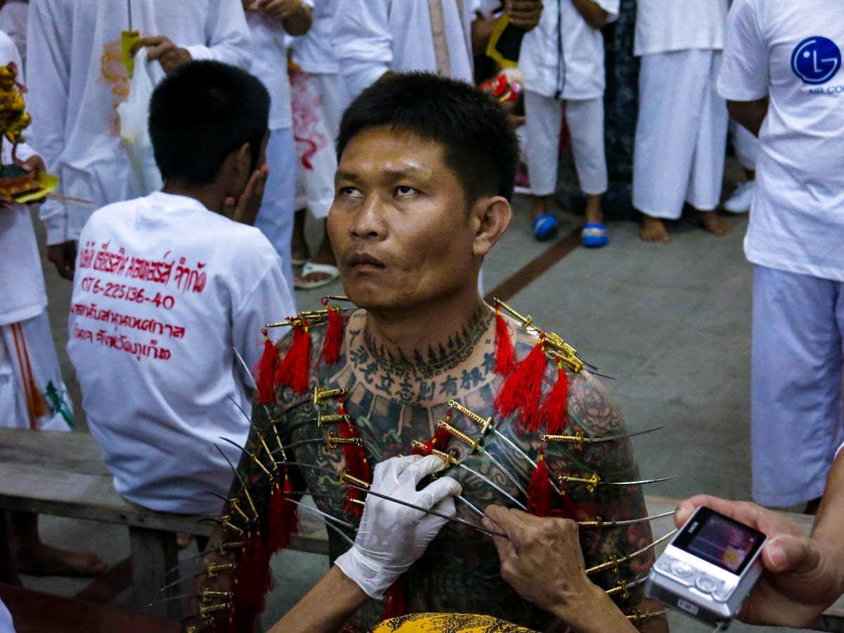 A Peranakan local goes through a ritualistic painful experience during the Phuket Vegetarian Festival.