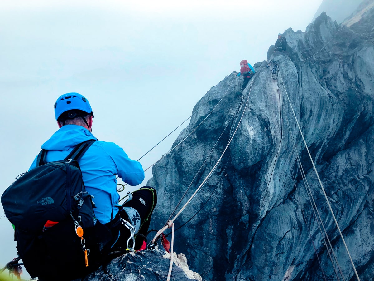 A climber gets ready to cross the rope bridge on Puncak Jaya