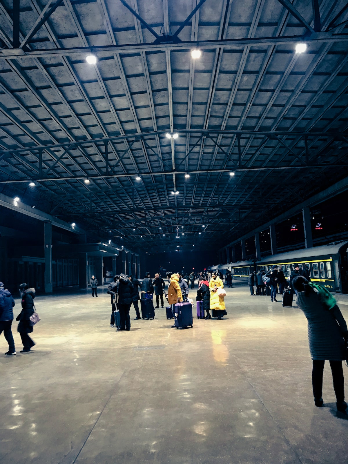 People gather in Pyongyang train station after arriving from the sleeper train from Dandong