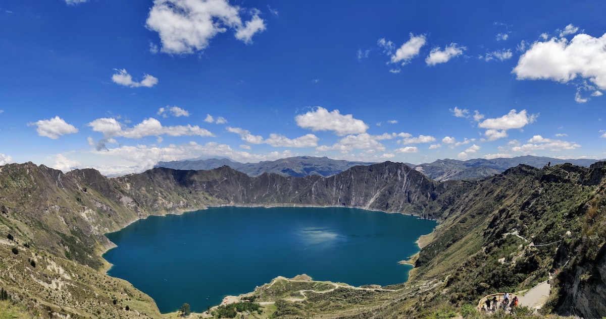 A large crater of turquoise water in Quito, Ecuador.