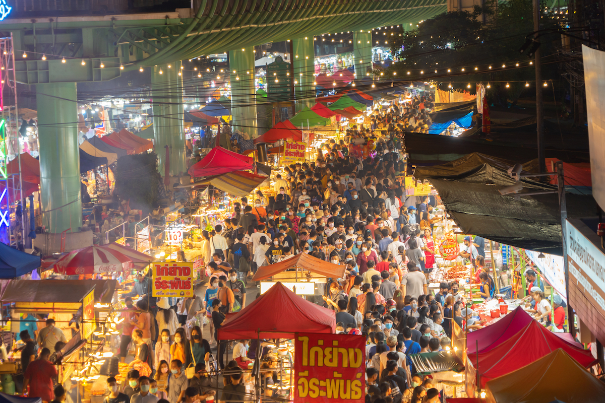 Night Market people walking street fair, Colorful tents in the train of Ratchada at Bangkok city, Thailand. Retail shops