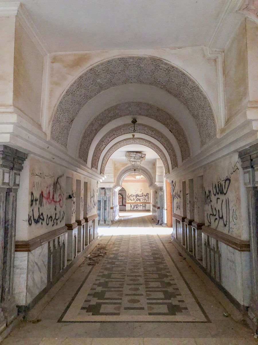 A desolate corridor with Arabic graffiti in Saddam Hussein's former palace in Babylon
