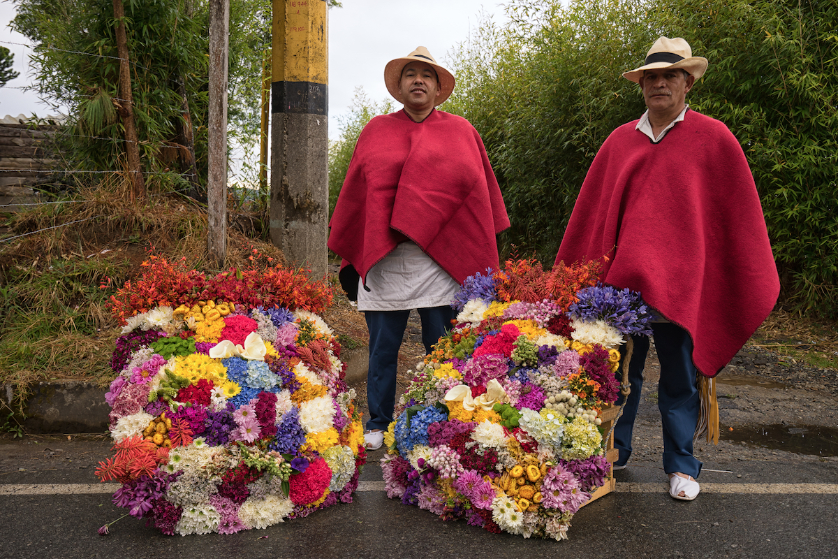 Farmers posing with floral displays made for the annual flower festival parade in Santa Elena, Colombia