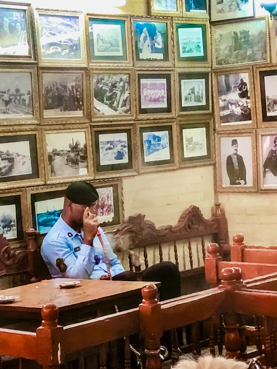 A policeman smokes shisha in Shahbandar Coffee Shop, Baghdad