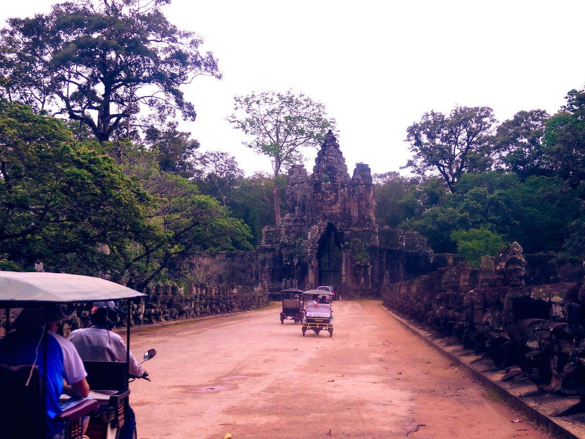 Tuk-tuks driving through Angkor Wat in Siem Reap, Cambodia. 