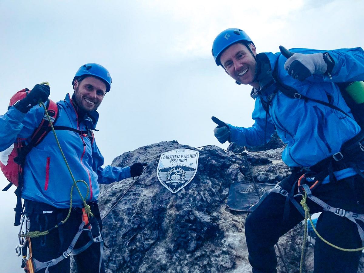 Climbers celebrate at the summit of Puncak Jaya