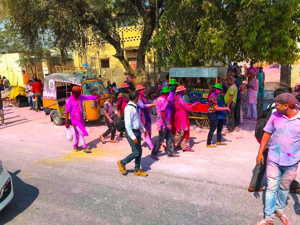 Crowds walk in the street during Holi