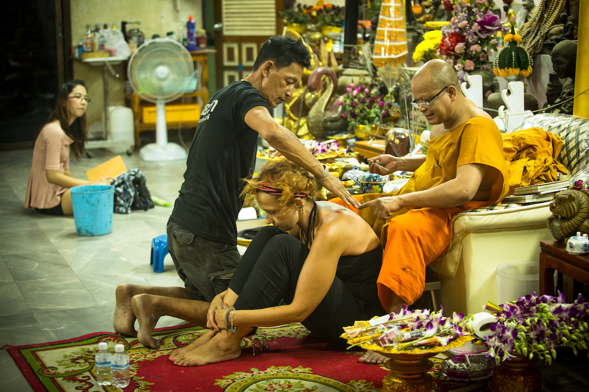 A monk makes traditional tattooing at a Thai festival.