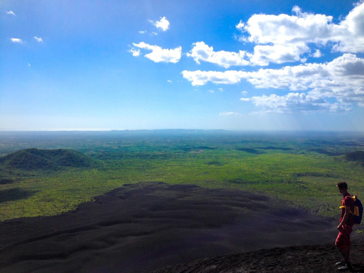 A man looks out into the horizon from the top of a volcano in Nicaragua. 