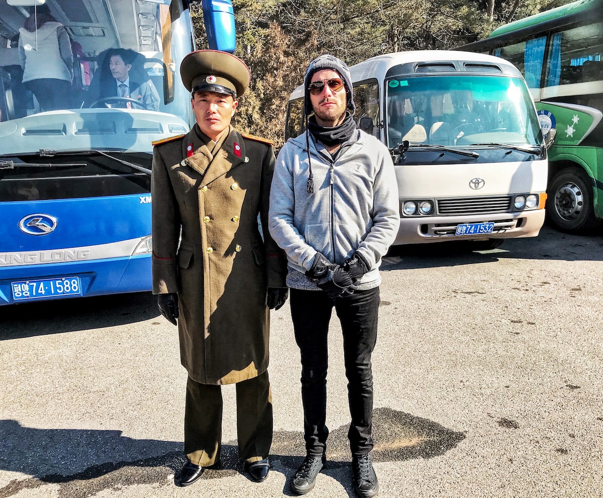 A male tourist poses with a North Korean soldier