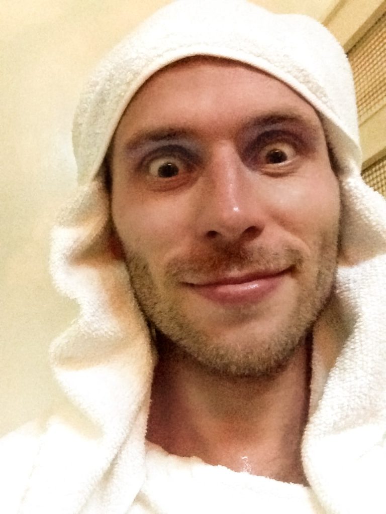 Man making a silly face with a towel wrapped around his head