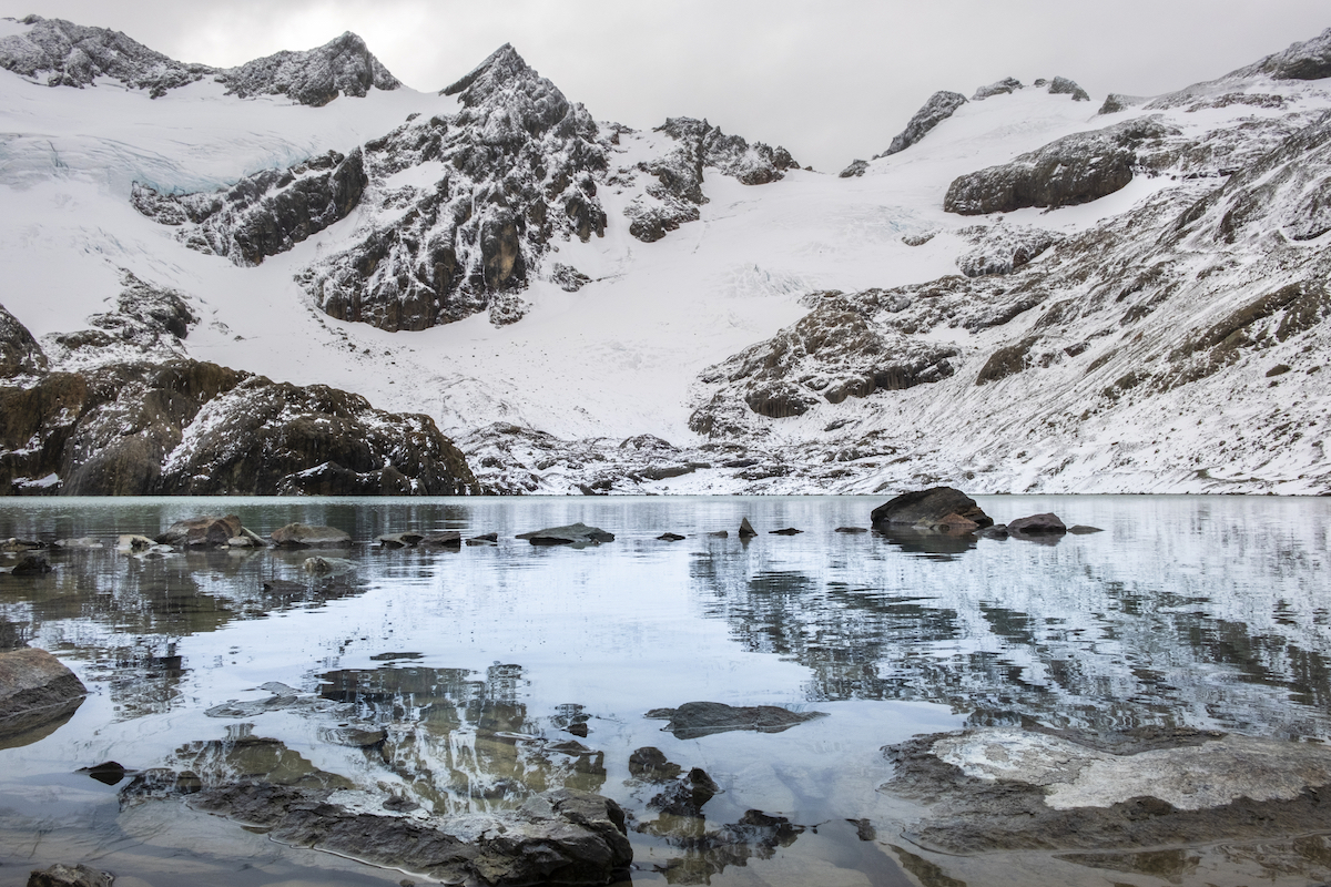A beautiful lagoon where the Vinciguerra glacier is reflected with its snowy mountains