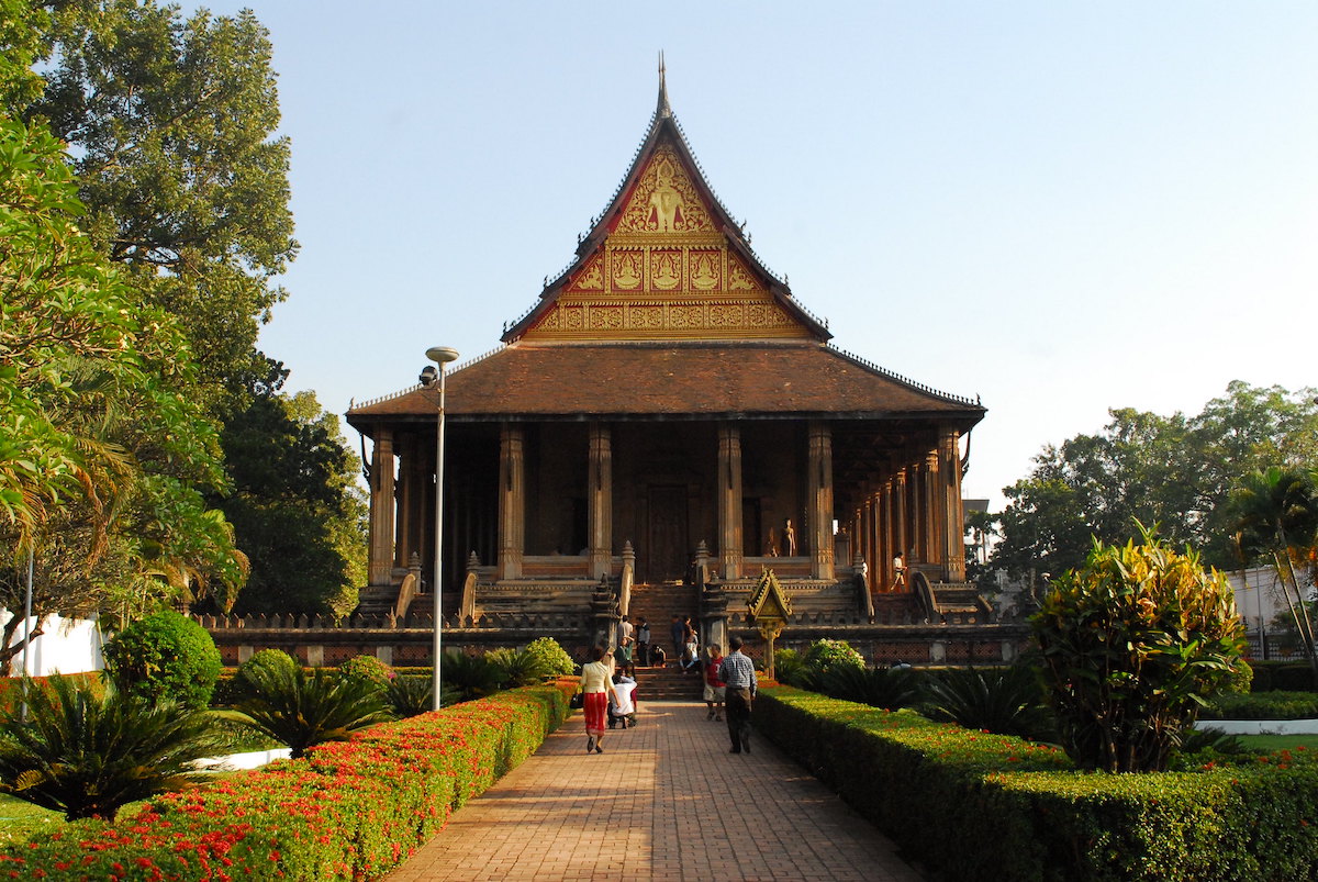 People attend a golden temple in Laos