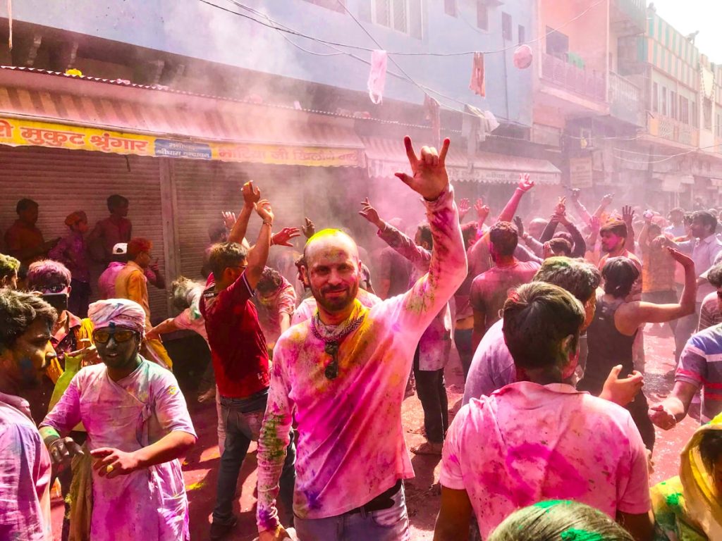 Male tourist celebrating Holi in India