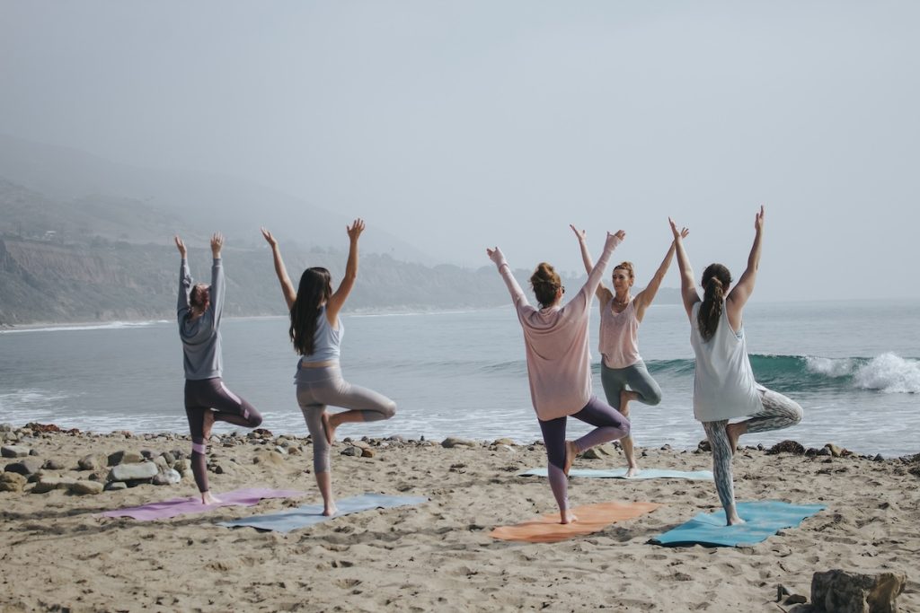 Women perform yoga at a yoga retreat