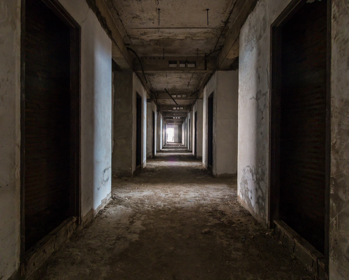 A long corridor in a creepy abandoned house. 