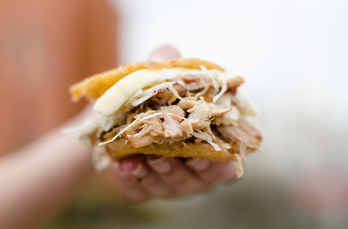 a meat-filled snack in a Colombian arepa.