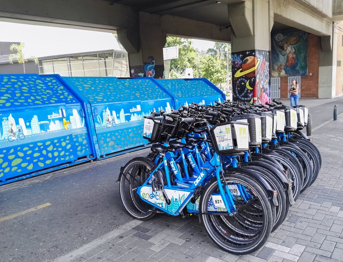 A large volume of blue bicycles parked up alongside each other. 