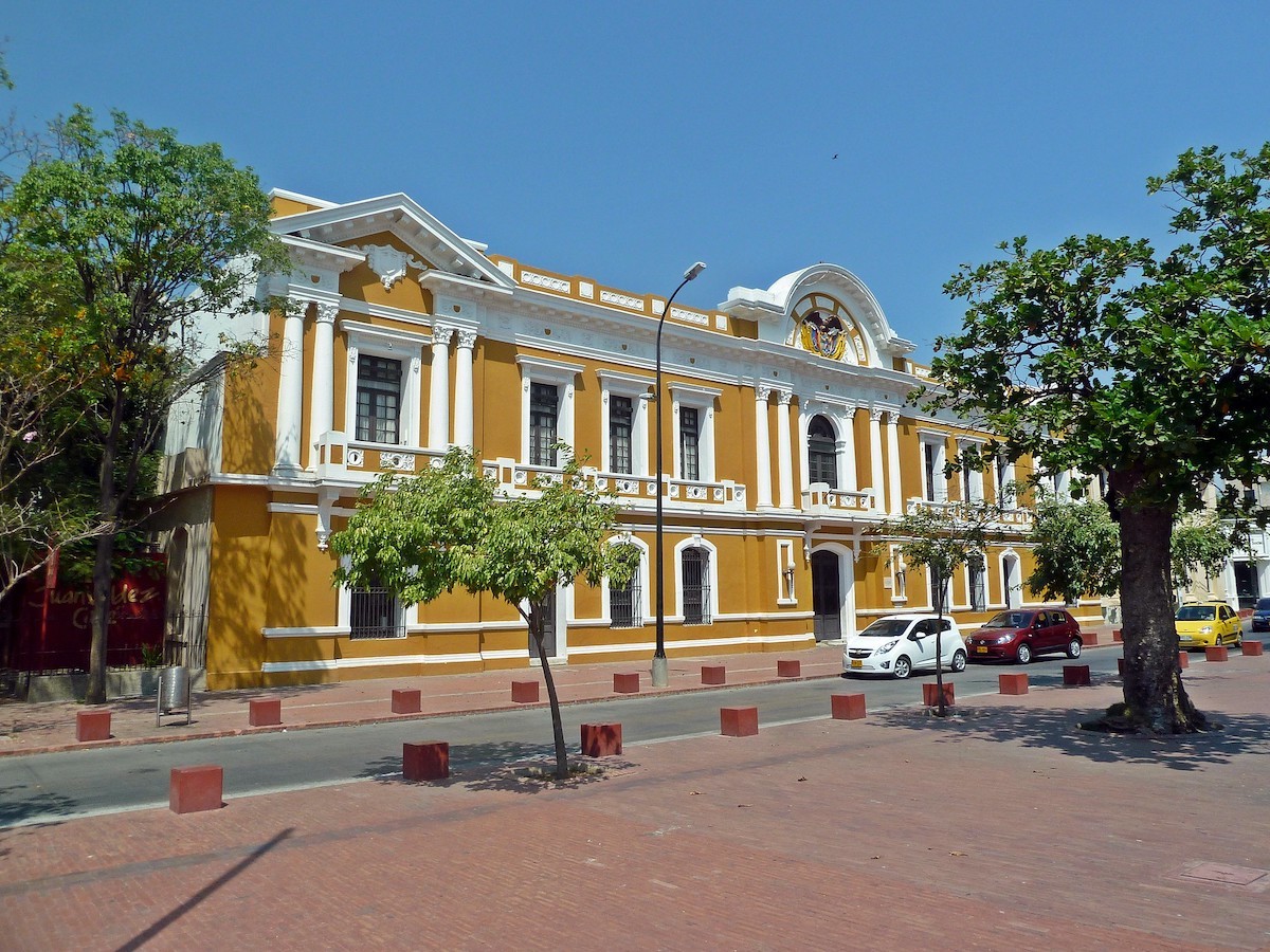 a striking yellow and white building in Santa Marta Historical Center, Colombia.