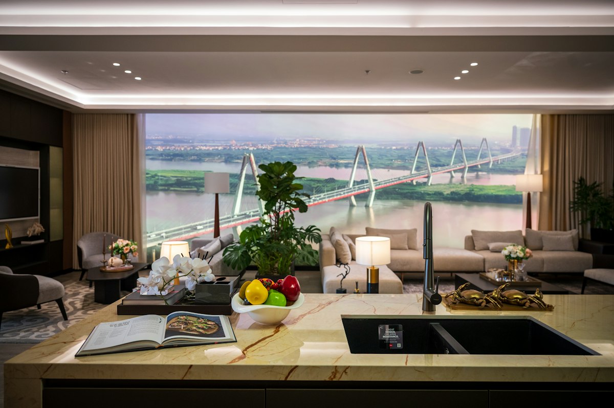 Why Your Next City Break Should Skip the Hotel Chain | city apartment living room river view Modern city apartment living room with a river and bridge view through large windows