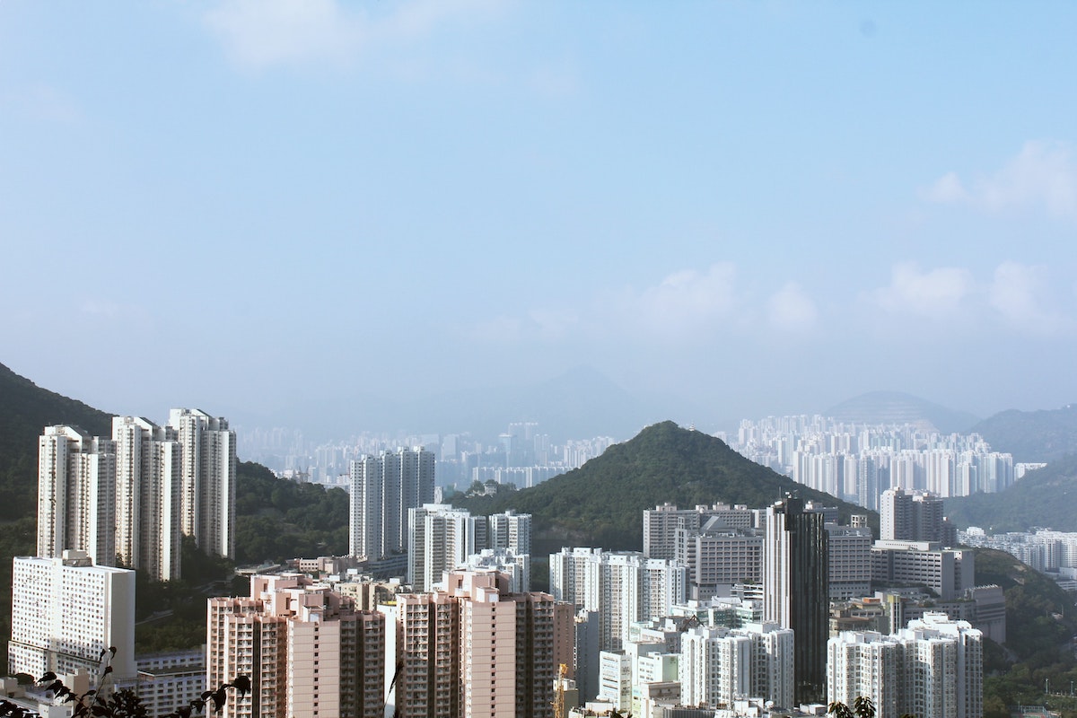 A large hill towers above skyscrapers in Hong Kong