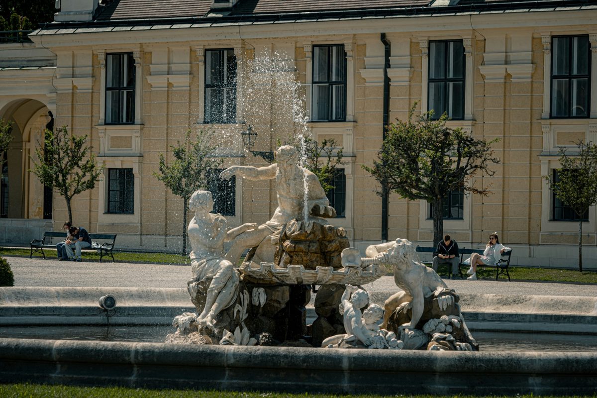Empires and Borders: The History Behind Central Europe's Capitals | elaborate stone fountain in front of a large historic building Elaborate stone fountain in front of a large historic building