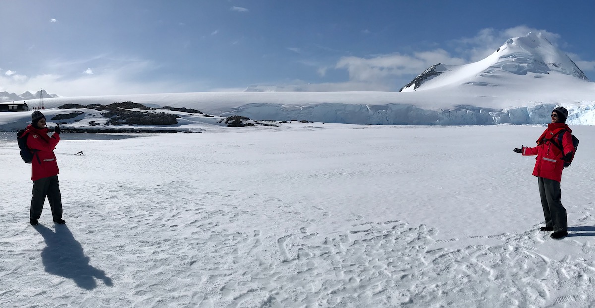 An image of a man smiling at himself in another pose during a trip to Antarctica. 