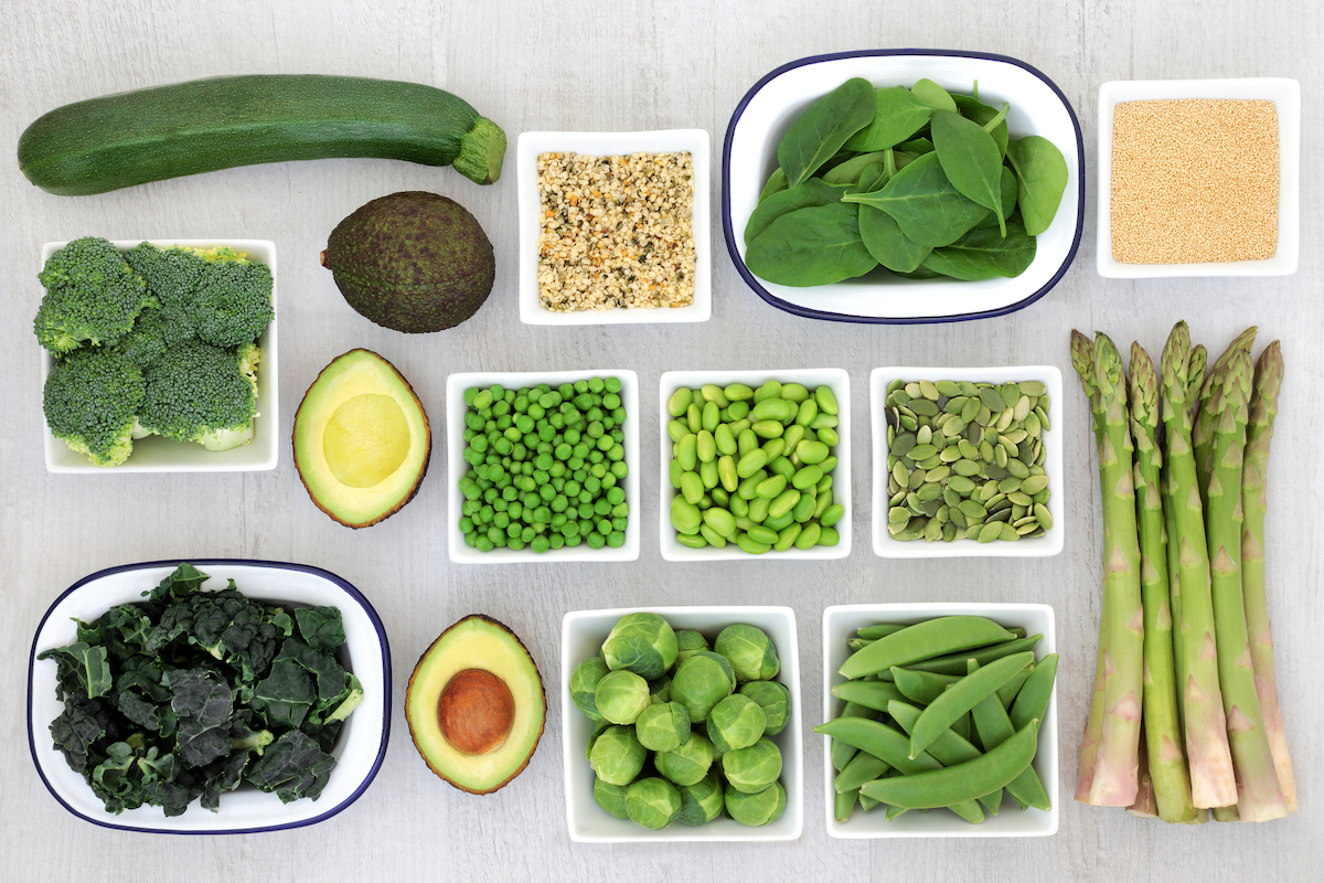 Health food selection for a healthy diet with seeds, amaranth grain and fresh green vegetables on rustic wood background. 