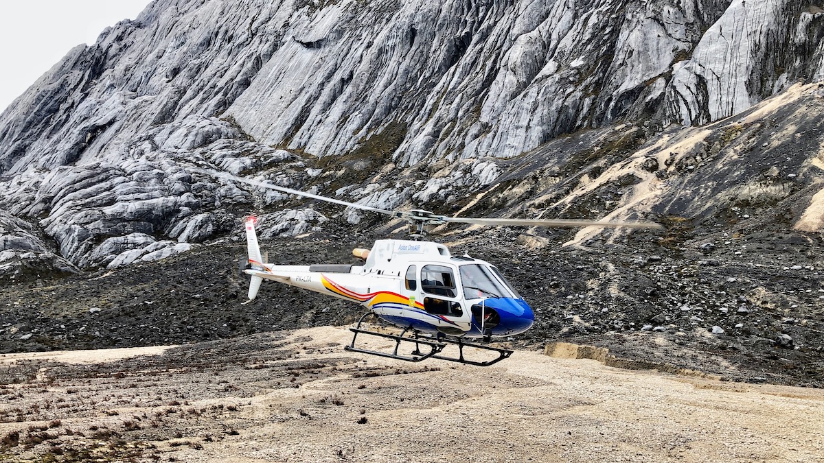 A helicopter lands on Puncak Jaya mountain in West Papua, Indonesia on the island of Guinea.