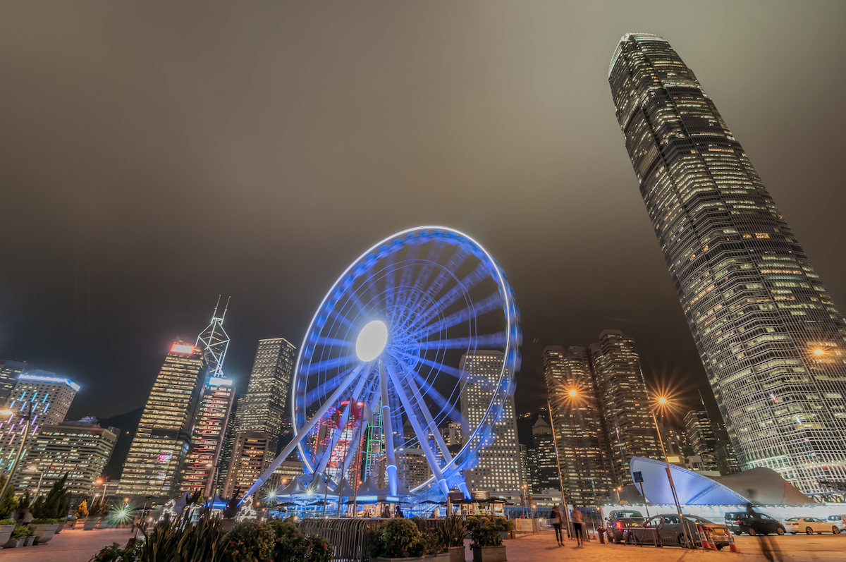 A lit-up Ferriss Wheel at night in Hong Kong