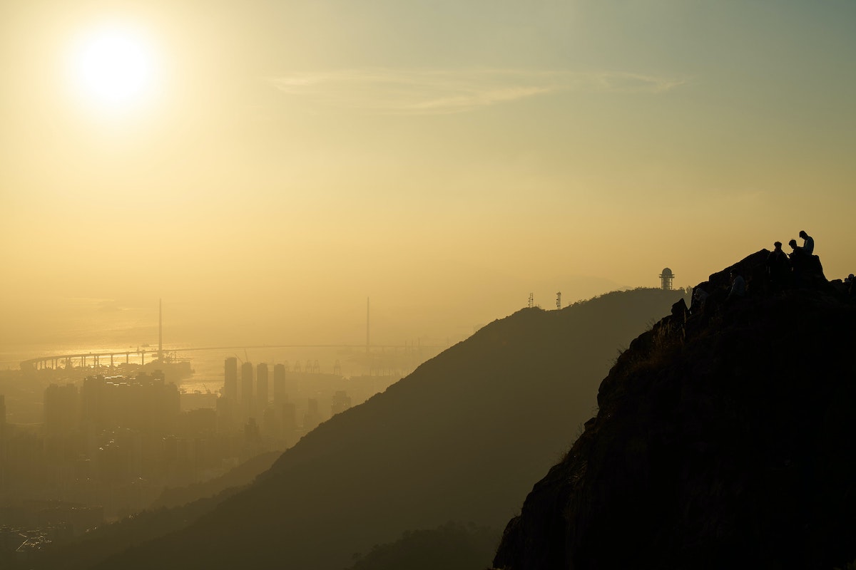 A foggy hill overlooking a bridge in Hong Kong.