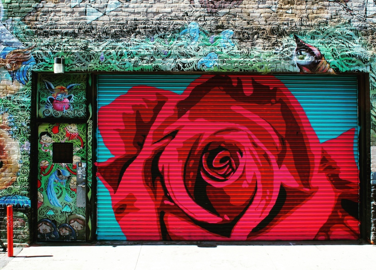 A mural of a red rose on a garage door in Downtown Fresno