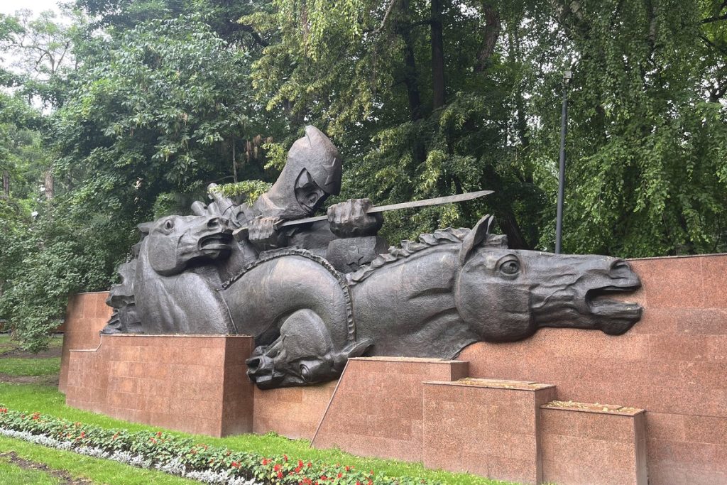 Bronze sculpture of horses and a helmeted warrior in Panfilov Park, Almaty