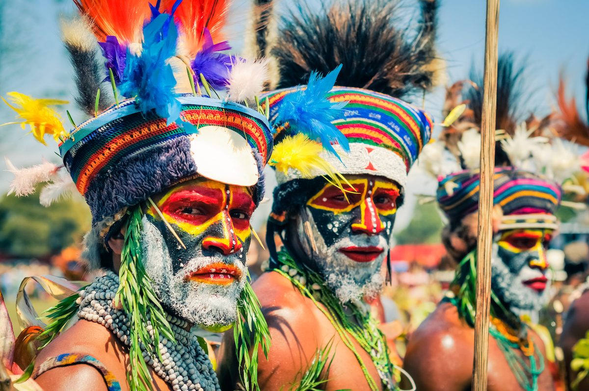 Hagen show, Papua New Guinea - Two native half-naked men with colours on their faces and beards during Hagen show, Papua New Guinea. Documentary editorial.