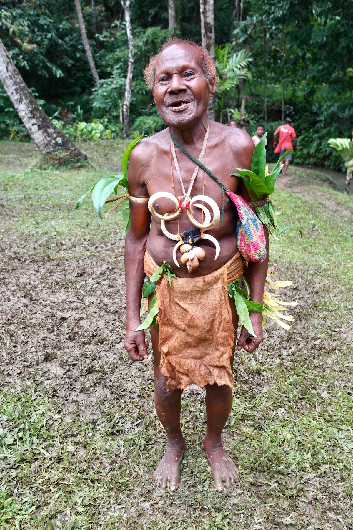 A tribesman in traditional indigenous attire smiles in Papua New Guinea