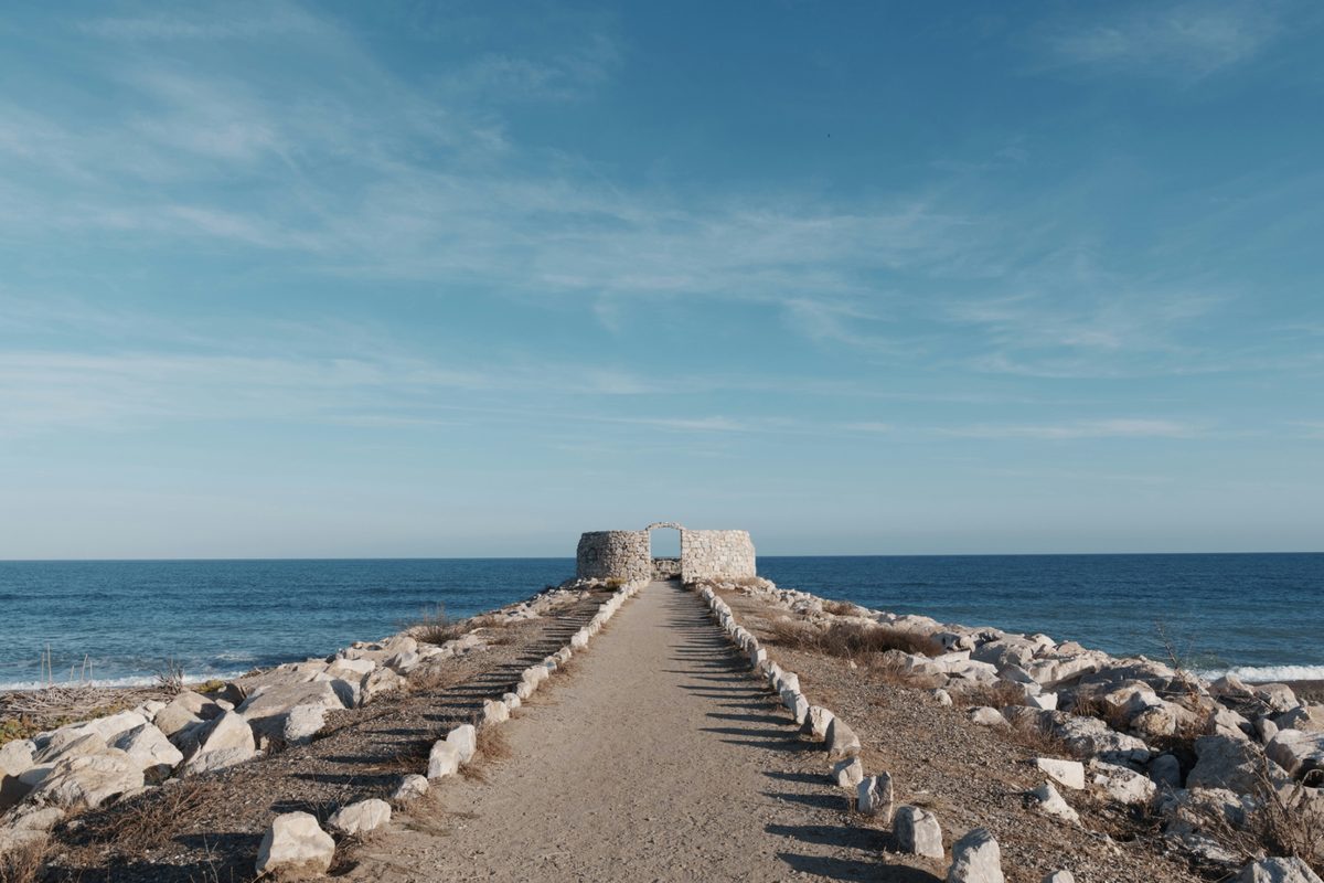 Budgeting for a Spain Trip: Costs Beyond the Plane Ticket | path leading to stone structures by the ocean Path leading to stone structures by the ocean
