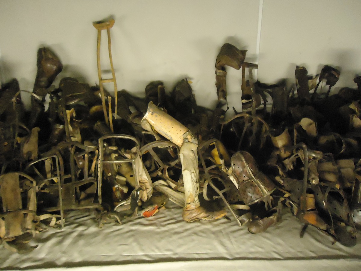 Prosthetic limbs of the victims of Auschwitz are shown behind a glass at the Auschwitz Museum